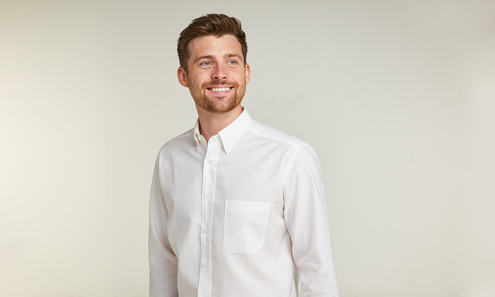 man smiling and looking into the distance wearing a White Non-Iron Pure Cotton Twill Shirt by double two